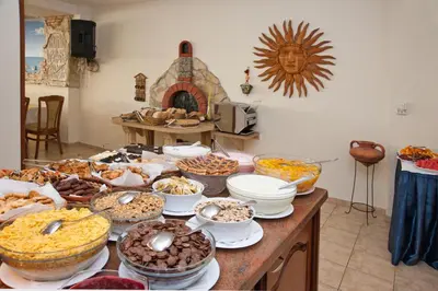 a table topped with lots of different types of food at Hotel Villa List in Sozopol