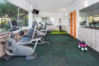 a gym with treadmills and exercise equipment in a building at Hotel Villa List in Sozopol