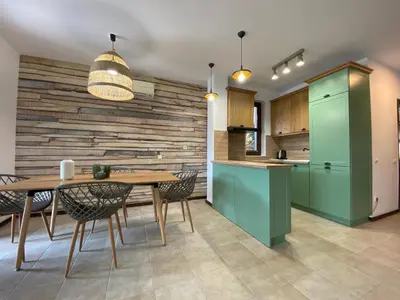 a kitchen and dining room with a table and chairs at Sozopolis Holiday Village in Sozopol