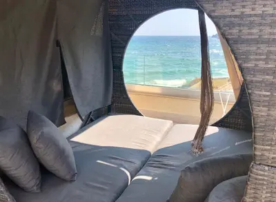 a room with a couch and a window with the ocean at Villa Lili in Sozopol