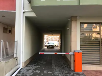 a hallway with a car parked in a building at Bright, Comfortable and Cozy Apartment in Burgas City