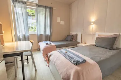 a bedroom with two beds and a table and a desk at City Center apartament “MARTA” in Varna City