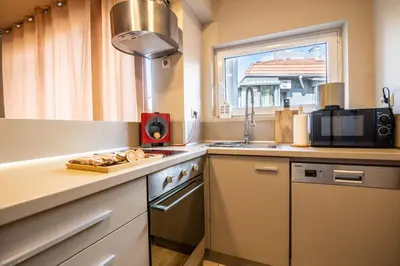 a kitchen with a sink and a stove top oven at City Center apartament “MARTA” in Varna City