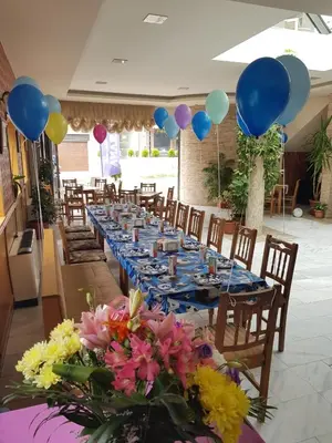 a long table with balloons and flowers on it at Mirana Family Hotel in Burgas City
