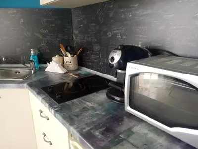 a kitchen counter with a microwave and a sink at Aura in Primorsko