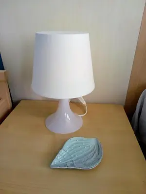 a lamp on a table with a mask on it at Aura in Primorsko