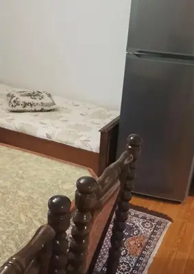 a woodenorah in front of a bed in a room at Apartment Marchela in Nesebar