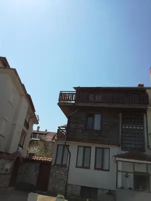 an old house in the middle of two buildings at Apartment Marchela in Nesebar