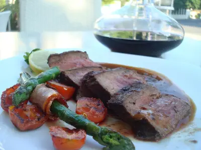 a plate of food with meat and vegetables on a table at Karlovo Hotel in Sunny Beach
