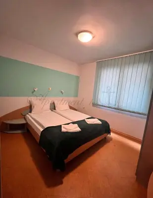 a large bed in a bedroom with a window at Sozopol House Dimitrovi in Sozopol