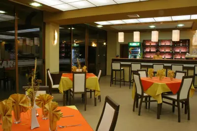 a restaurant with tables and chairs and a bar at Hotel Iskar & Aquapark - All Inclusive in Sunny Beach