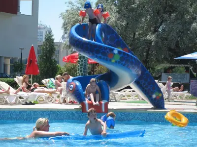 a group of children playing in a swimming pool at Hotel Iskar & Aquapark - All Inclusive in Sunny Beach
