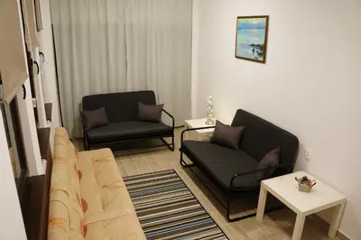 a living room with two chairs and a couch at Villa Burkopolis in Sozopol