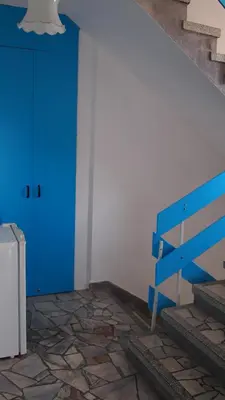 a blue bench in a room with a blue door at Villa Burkopolis in Sozopol