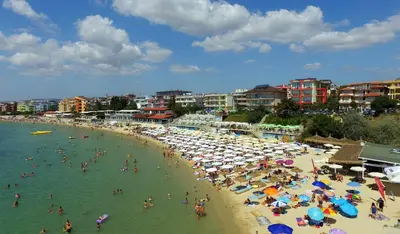 a group of people on a beach with umbrellas at Къща Веси VeSea in Nesebar