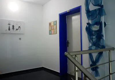 a hallway with a blue door and a staircase at Къща Веси VeSea in Nesebar