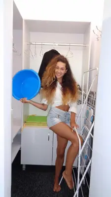 a woman sitting on a bunk bed holding a blue frisbee at Къща Веси VeSea in Nesebar