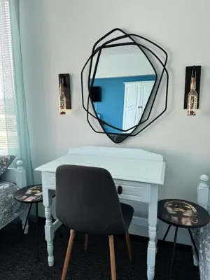 a desk with a chair and a mirror on a wall at Къща Веси VeSea in Nesebar