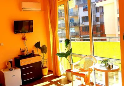 a room with a large window with a table and a chair at Къща за гости Вълчеви Несебър in Nesebar