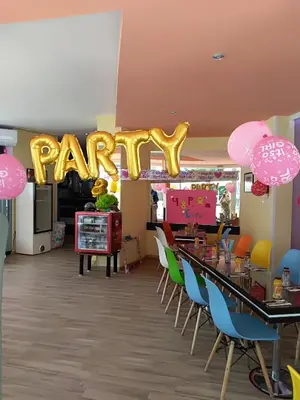 a party room with a giant party sign and chairs at Family Hotel Varna in Varna City