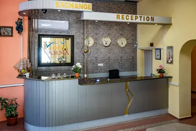 a lobby with a reception counter in a building at Family Hotel Varna in Varna City
