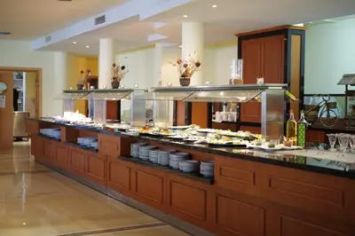 a buffet line with plates of food on display at Perla Plaza Hotel - All Inclusive in Primorsko