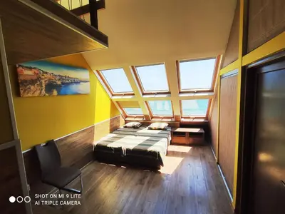 a bedroom with a bed in a room with windows at Hemingway rooms in Happy Beach in Varna City