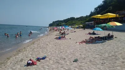 a group of people laying on a beach at Hemingway rooms in Happy Beach in Varna City