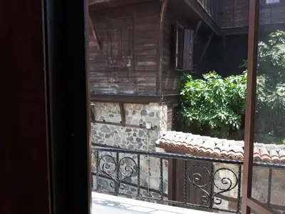 an open door to a balcony with a plant at Guest House Antique in Sozopol