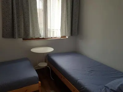 a bedroom with a bed and a table and a window at Guest House Antique in Sozopol