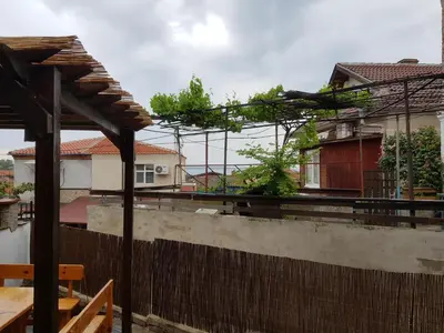 a tree laying on the roof of a house at Guest House Antique in Sozopol