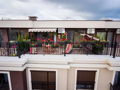 a building with a balcony with flowers on it at Sky Garden Apartment Burgas in Burgas City