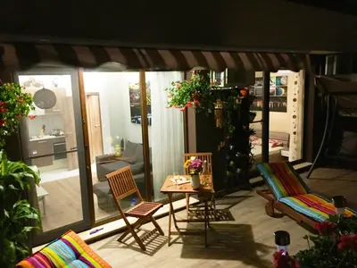 a patio with two chairs and a table at Sky Garden Apartment Burgas in Burgas City
