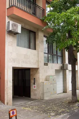 a building with a door and a tree in front of it at Dreamcatcher's home by RV Apartments in Varna City