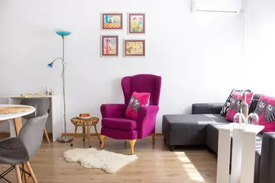 a living room with a purple chair and a couch at Dreamcatcher's home by RV Apartments in Varna City