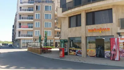 a building with a pizza shop on the side of a street at Aglaya 2 in Pomorie