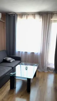 a living room with a couch and a glass coffee table at Villa Tuna in Sveti Vlas