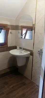 a bathroom with a sink and a mirror at Джорджия in Kiten
