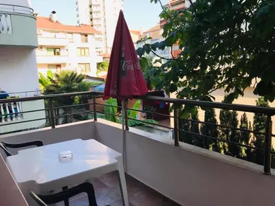 a table and an umbrella on a balcony at Джорджия in Kiten