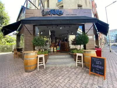 a store with tables and stools in front of a building at Arte Casa in Burgas City
