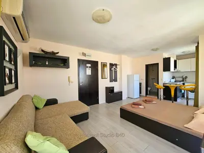 a living room with a couch and a table at Aпартаменти Хоризонт in Sozopol