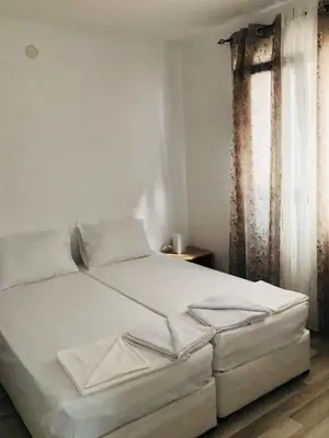 a white bed in a room with a window at Dream View in Byala