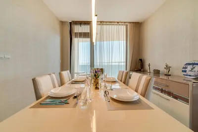 a dining room with a long table with chairs at Apartcomplex Golden Bay in Ravda