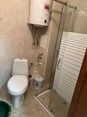 a bathroom with a toilet and a glass shower at Частен апартамент Лагуна - Private Two-Bedroom Apartment Laguna in Primorsko