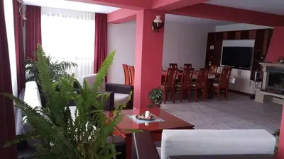 a living room with a couch and a table at Holiday Home Paulovnia in Tschenge