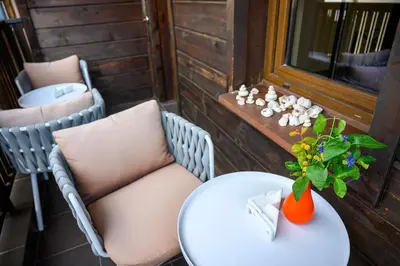 a table and chairs on a balcony with a vase with a plant at Effect Boutique Villa Azzura - Adults Only in Nesebar