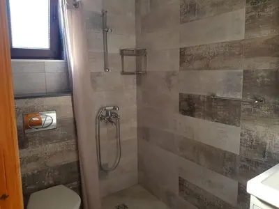 a bathroom with a shower and a toilet at Одеса 37 in Sozopol