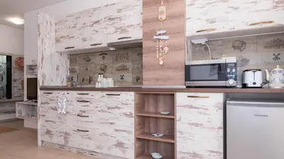 a kitchen with a counter with a microwave and a refrigerator at Lora boutique in Pomorie