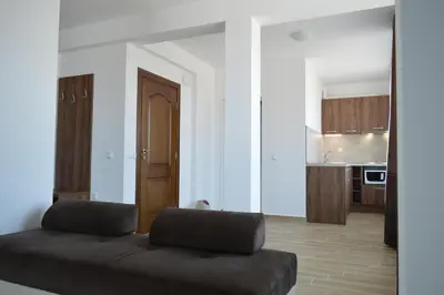 a living room with a couch and a kitchen at SummerHouse Lozenets in Lozenets