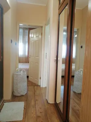 a hallway with a mirror and a room with a bed at Apartament ,,EDELVAIS- LUX'' in Nesebar